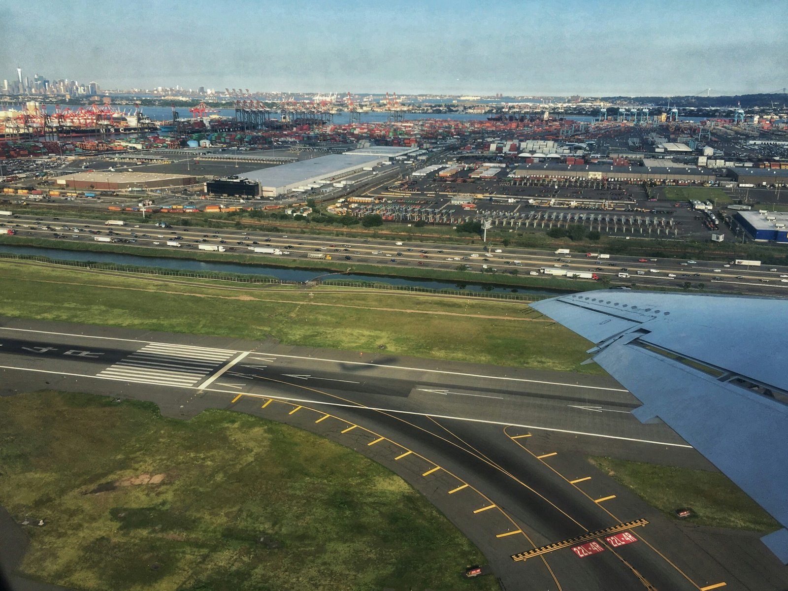 an aerial view of an airport with a body of water in the background